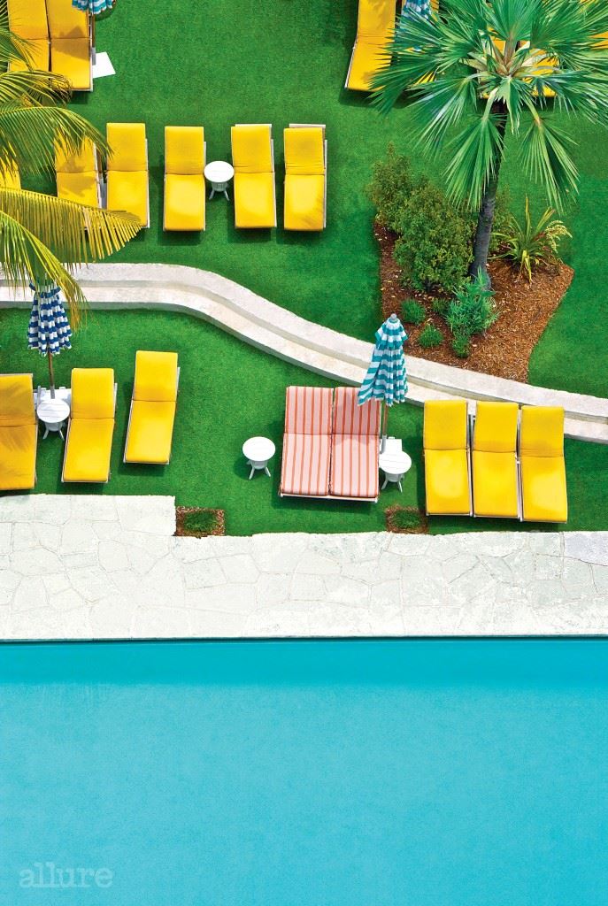 Relates to feature, Things that Make you go Boom, aerial view of swimming pool, yellow deck chairs, lawn, palm tree